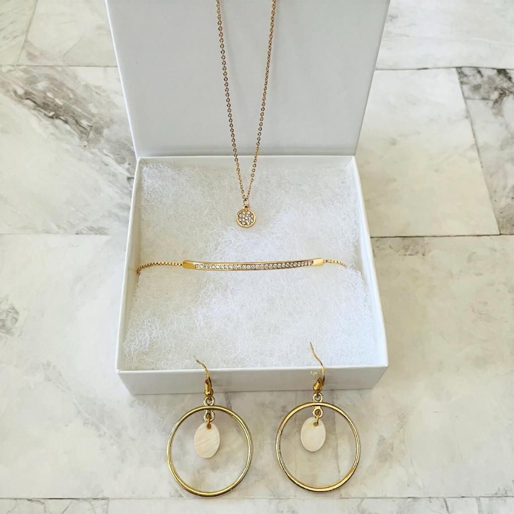 Gold Disc Necklace, Gold Hoop and Shell Earrings, and Gold Crystal Bar Bracelet