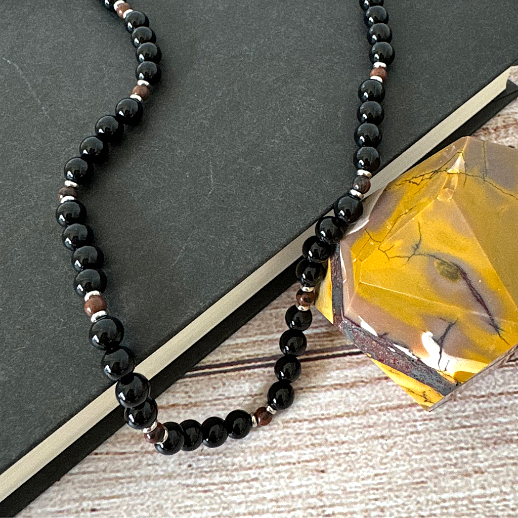 Black Onyx and Mahogany Obsidian Beaded Mens Necklace Displayed on A Book.