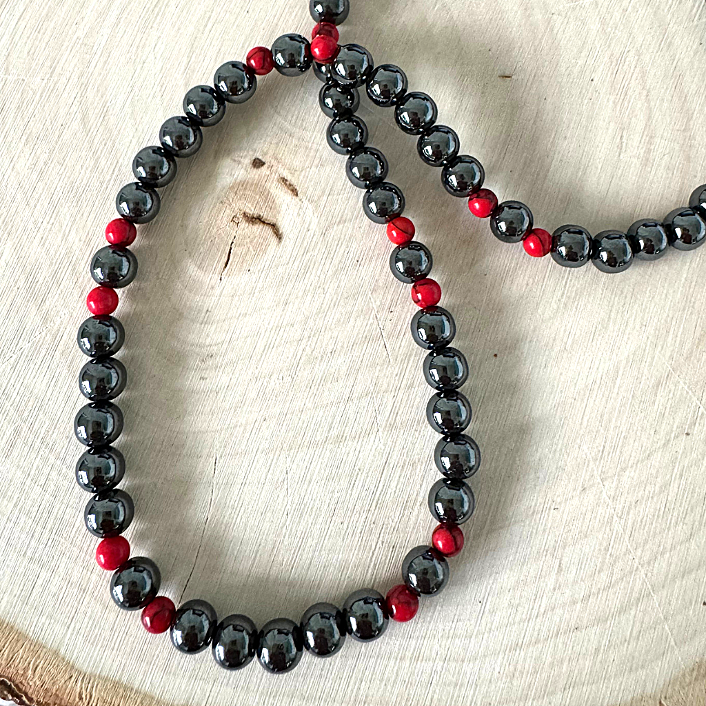 Men's Hematite and Red Howlite Beaded Necklace On Wood