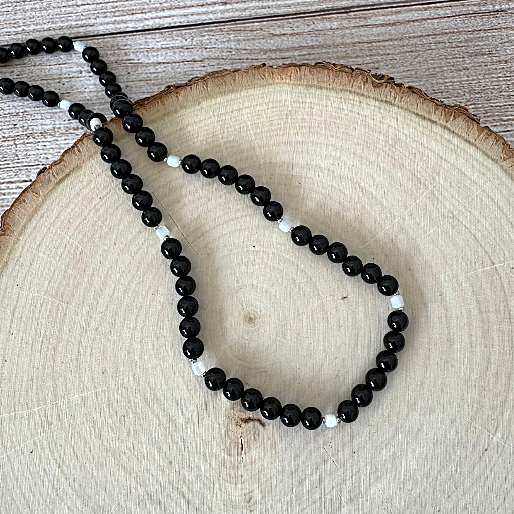 Mens 6mm Black Onyx and Mother of Pearl Beaded Necklace On Light Wood
