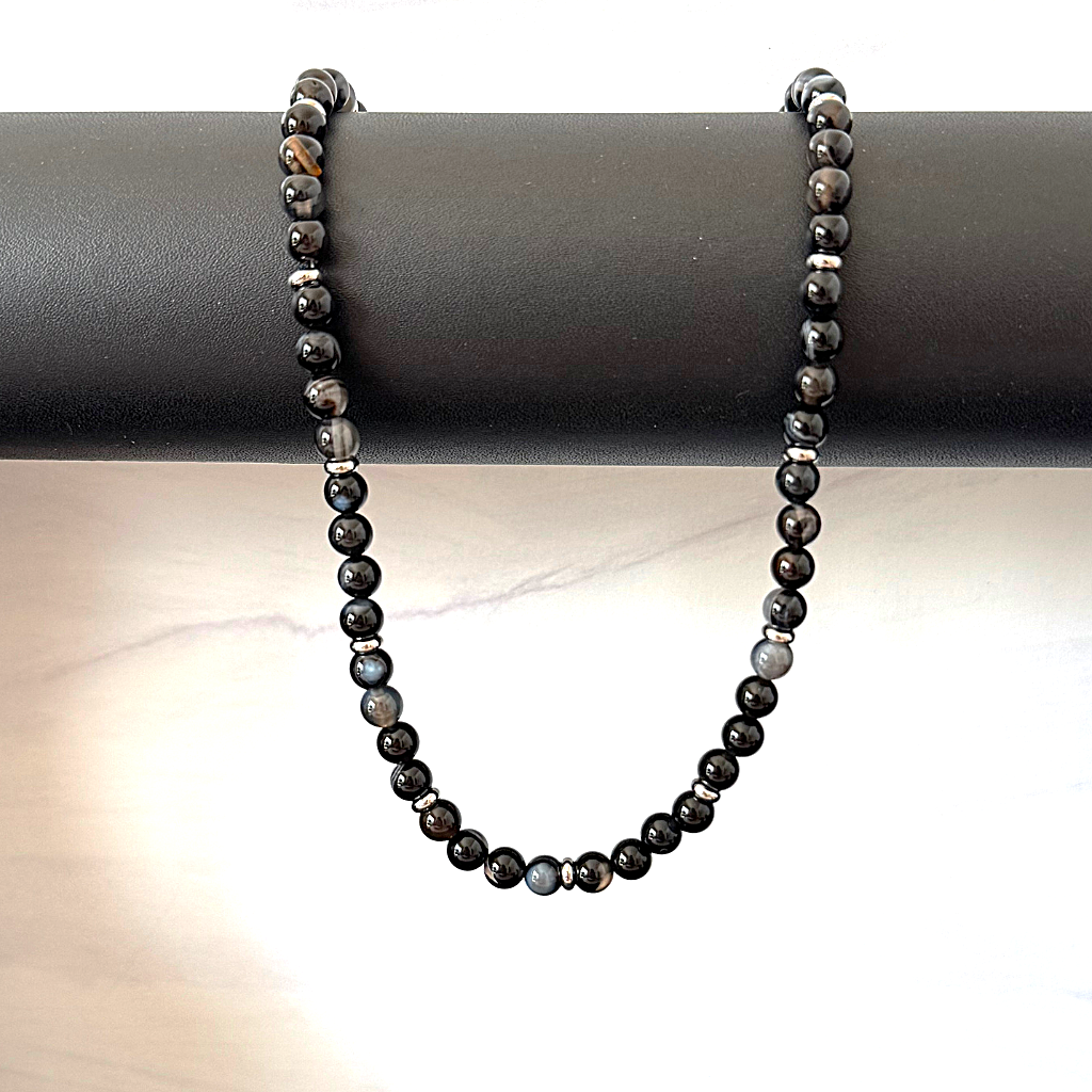 Mens 6mm Black Sardonyx and Silver Spacer Beaded Necklace Hanging On A Rod