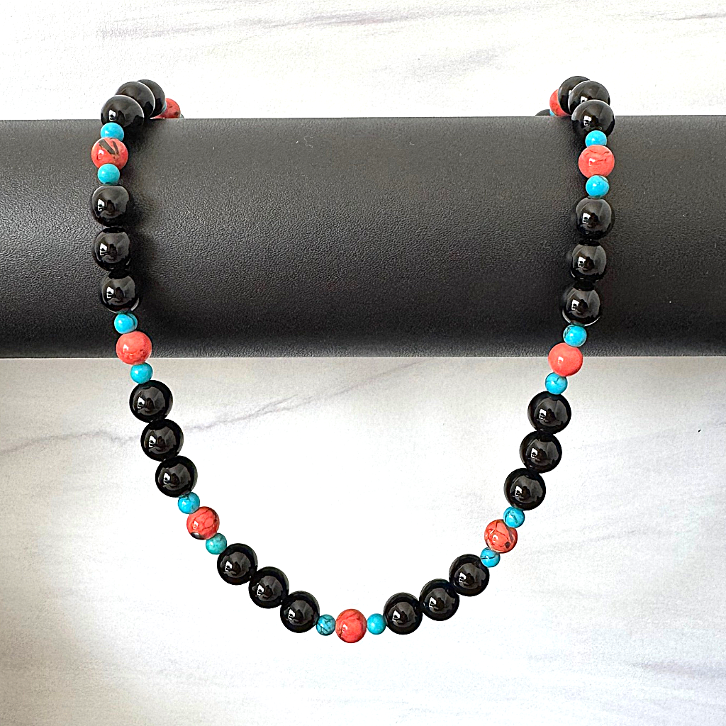 Mens Black Onyx Vermillion and Blue Howlite Beaded Necklace On A Jewelry Display