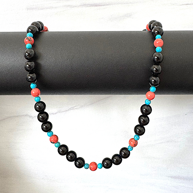 Mens Black Onyx Vermillion and Blue Howlite Beaded Necklace On A Jewelry Display