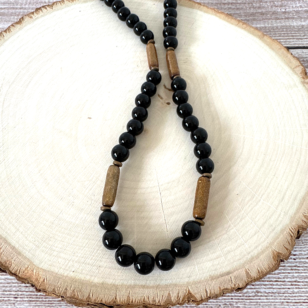Mens Black Onyx and Gold Coral Beaded Necklace On Wood.