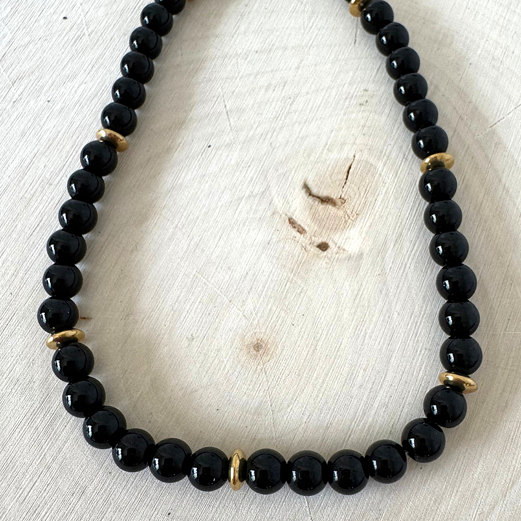 Mens Black Onyx and Gold Hematite Rondelle Beaded Necklace On Wood.