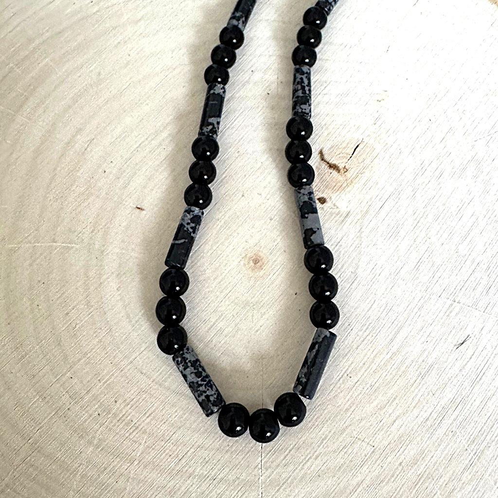 Mens Black Onyx and Snow Jasper Beaded Necklace On A Wood Table