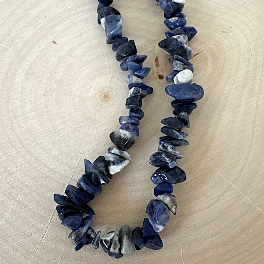 Mens Blue Lapis Chip Necklace on a wooden surface