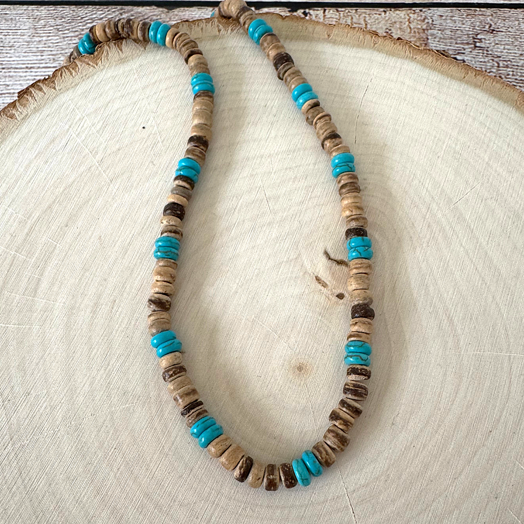 Mens Brown Coconut Shell and Magnesite Heishi Beaded Necklace on a wooden surface