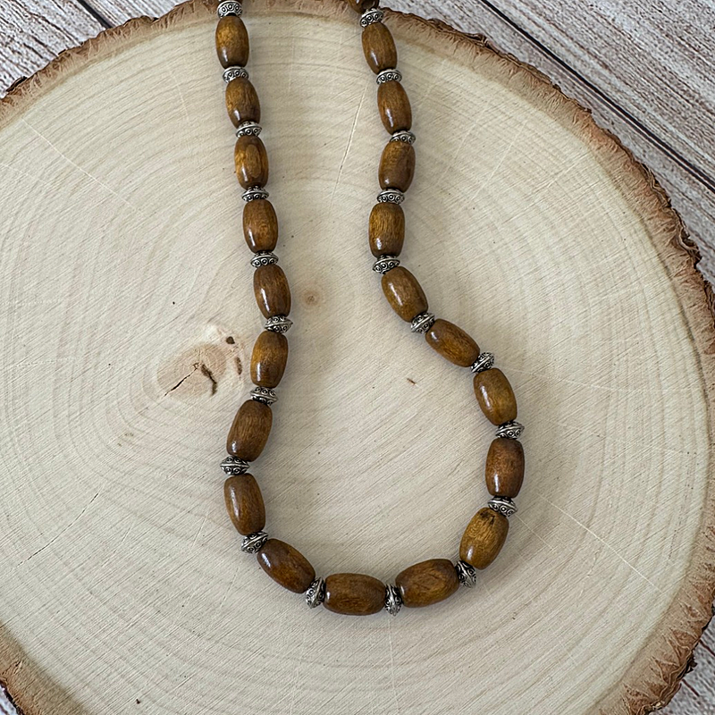 Mens Brown Wood Barrel and Silver Beaded Necklace On Wood.