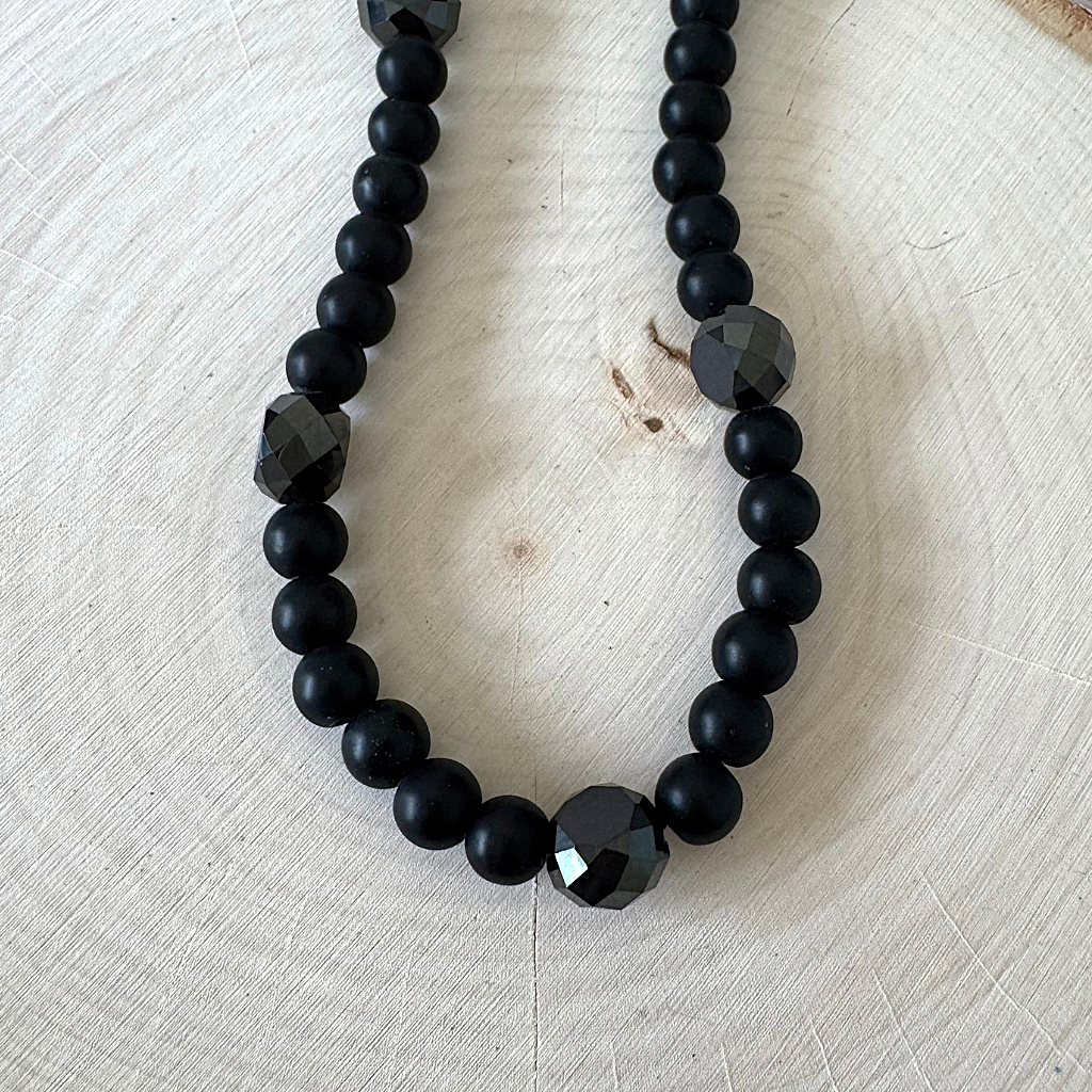Mens Matte Black Onyx Round and Faceted Beaded Necklace On Wood Table