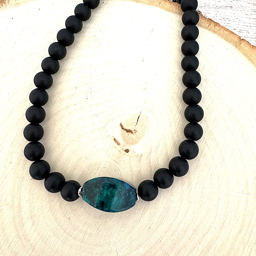 Mens Matte Black Onyx and Yellow Turquoise Stone Necklace On A Light Wood Board.
