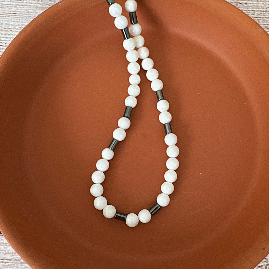 Mens White Shell and Black Hematite Tube Beaded Necklace On A Terracotta Dish