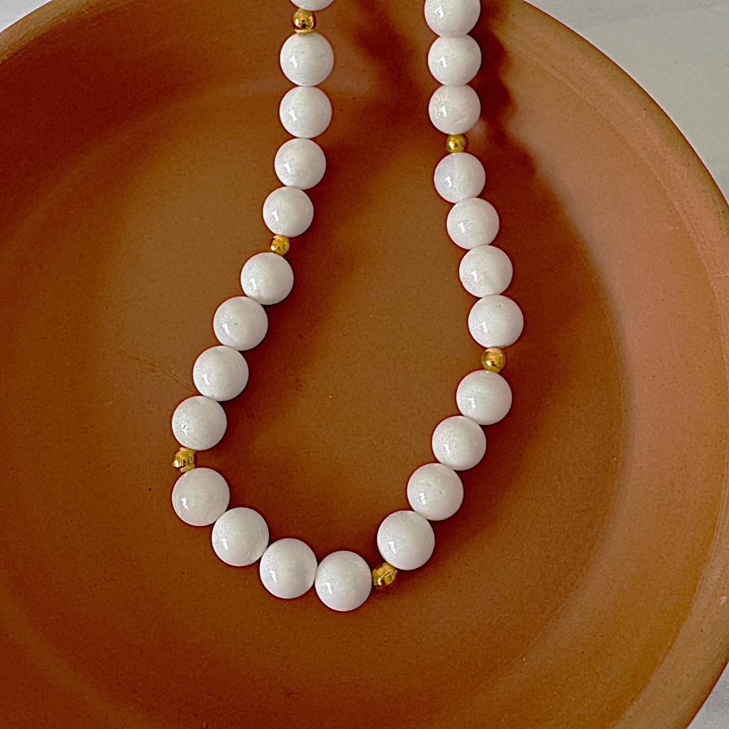 Mens White Shell and Gold Beaded Necklace Displayed