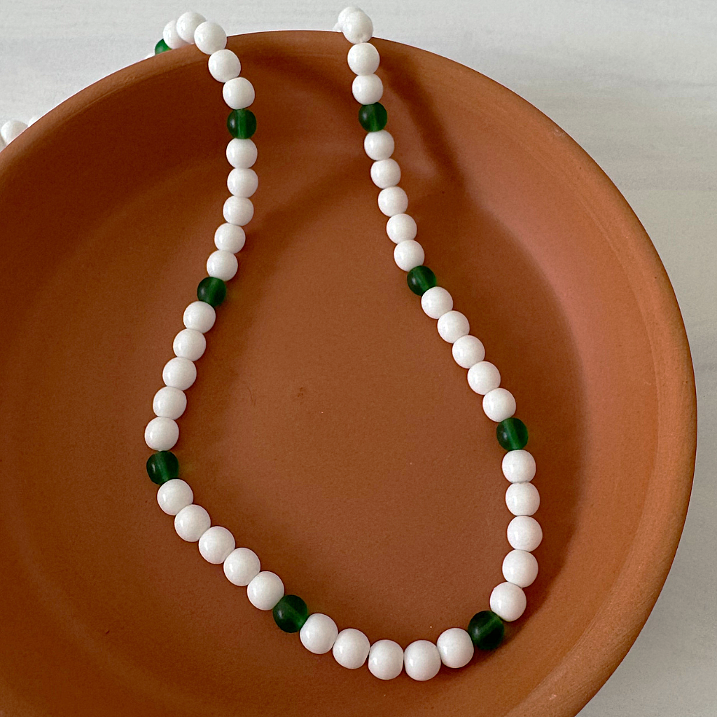 White and Green Beaded Mens Necklace On A Dish