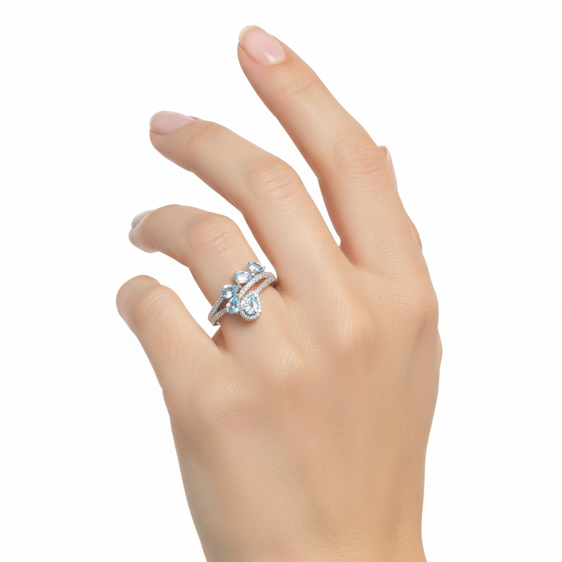 Blue Topaz Ring On A Womans Hand.