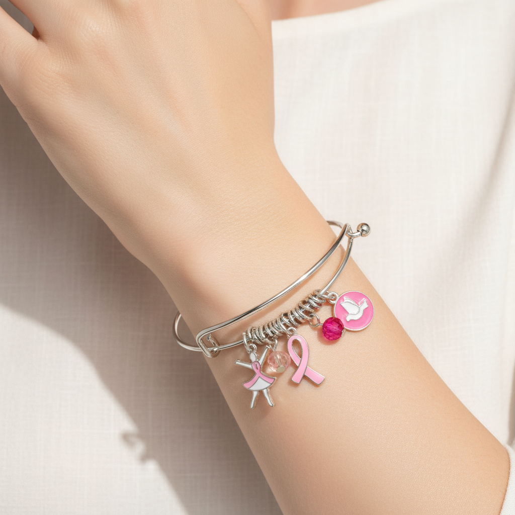 Pink Ribbon Breast Cancer Silver Bangle Bracelet On A Womans Wrist.