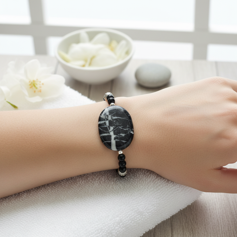 Black Marble Stone and Black Onyx Beaded Bracelet On A Wrist.