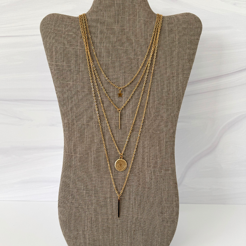 Four Gold Charm Layered Chain Necklace Featuring Bars, Disc, and Star.