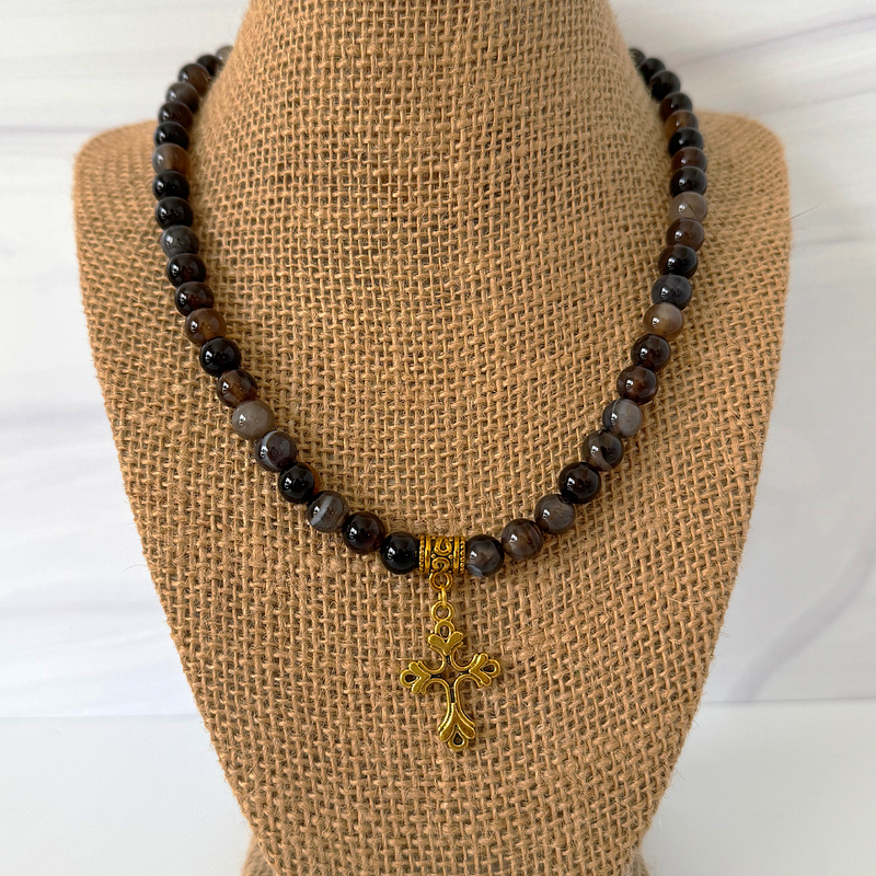Mens Black and Smoky 8mm Agate Beaded Necklace and Gold Cross Pendant On A Display.