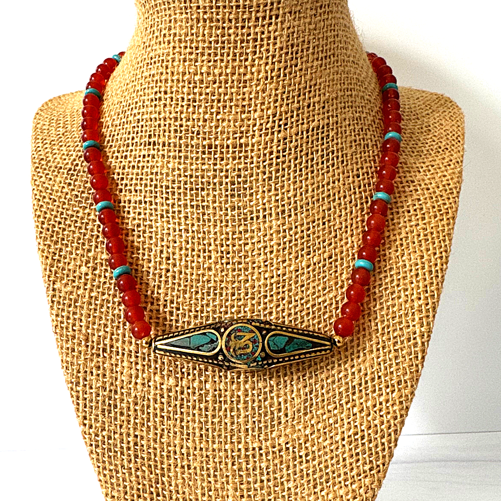 Mens Matte Carnelian and Turquoise Howlite Beaded Necklace With Metal Focal Bead On A Display