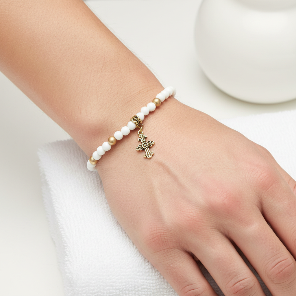 Mens White and Gold Beaded Cross Bracelet On A Mans Wrist.