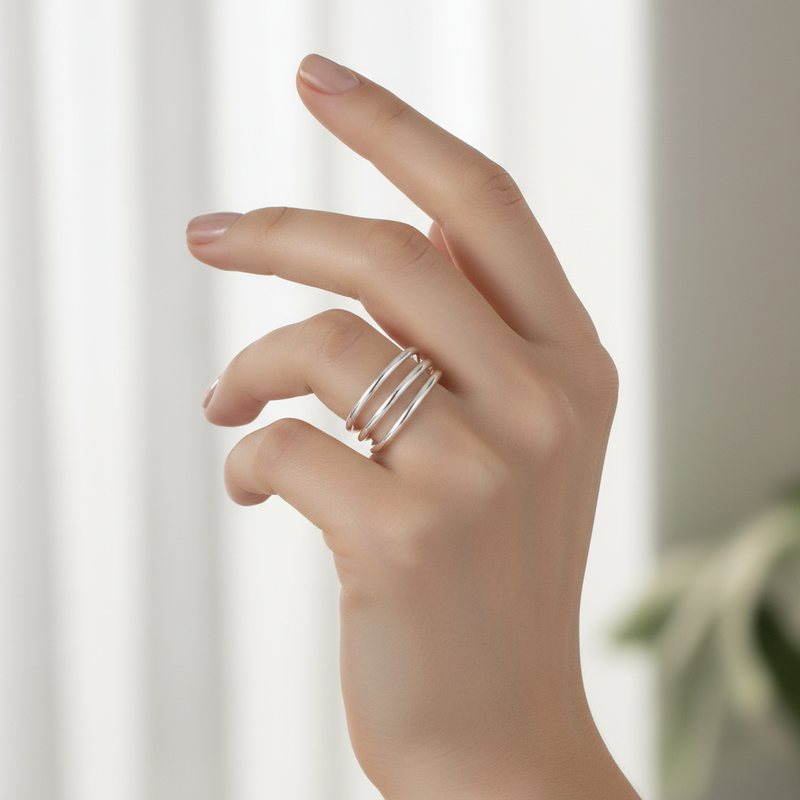 Multi Band Sterling Silver Ring On A Hand.