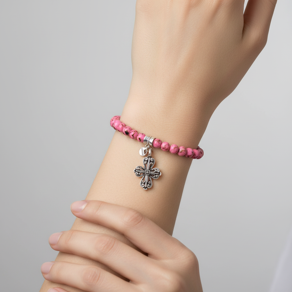 Pink beaded cross bracelet on woman model.
