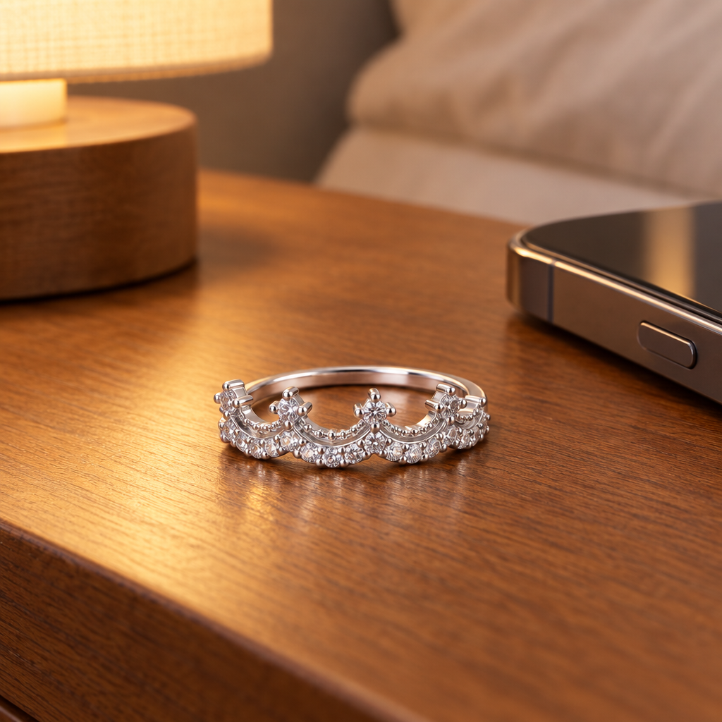 Sterling Silver CZ Crown Ring on a nightstand beside a cell phone