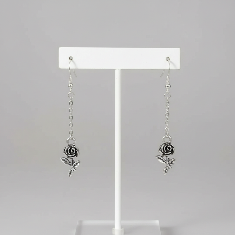 Rose Dangle Earrings On Jewelry Display.