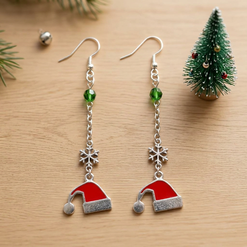 Santa Claus Christmas Stocking Hat Long Dangle Earrings on light brown wood beside a small Christmas tree