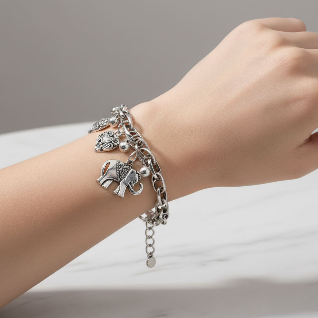 Silver Elephant and Heart Charm Bracelet On A Womans Wrist.
