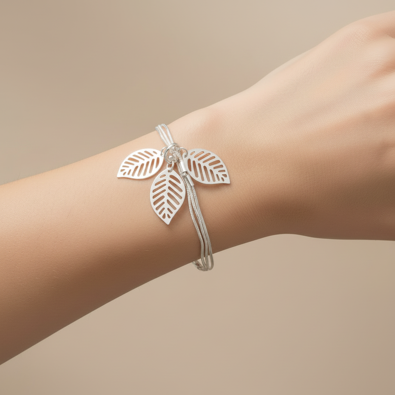 Silver Snake Chain Bracelet with Silver Charm Leaves On A Womans Wrist.