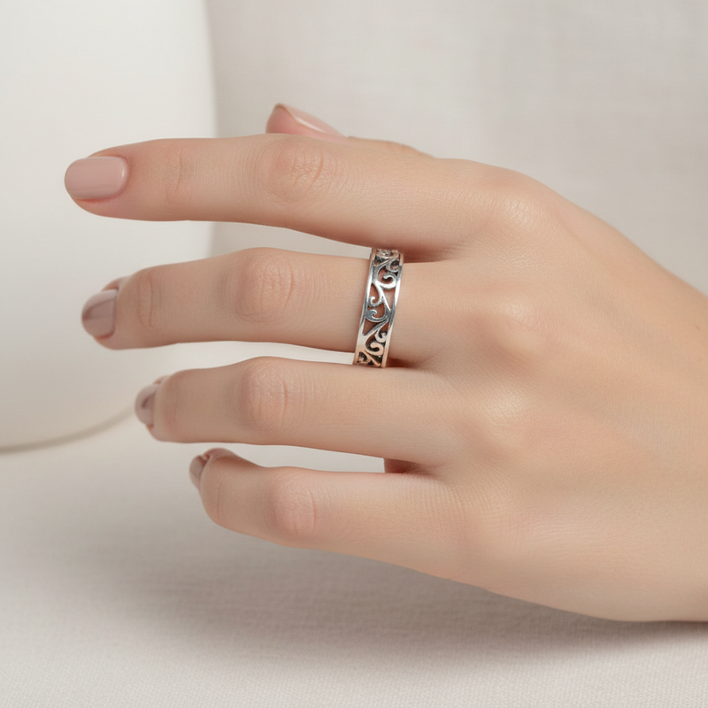 Sterling Silver Cut Out Wave Ring On A Womans Hand.
