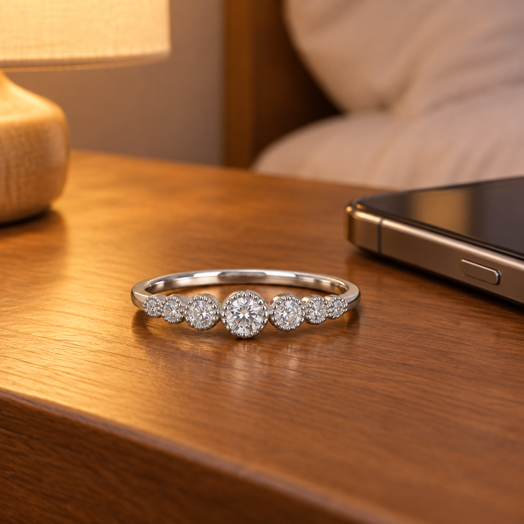 Sterling Silver CZ Round Stone Ring on a nightstand beside a cell phone
