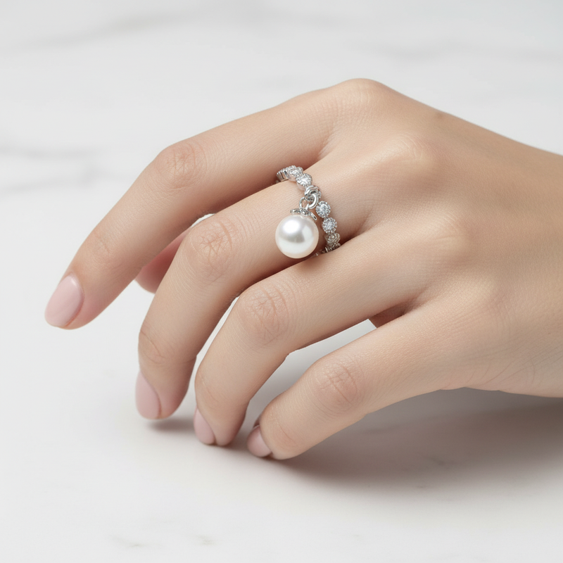 Sterling Silver Stackable CZ Ring With Drop Pearl On A Womans Hand.