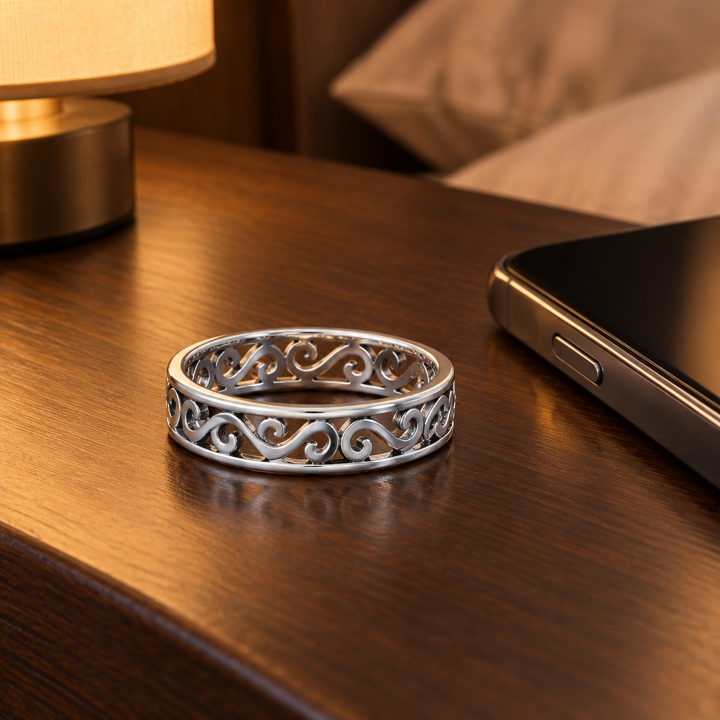 Sterling Silver Cut Out Wave Ring on a nightstand beside a cell phone