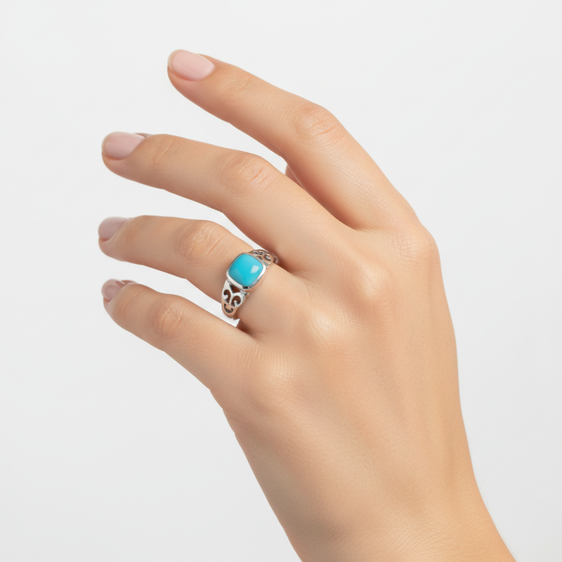 Turquoise square stone ring on a womans hand.