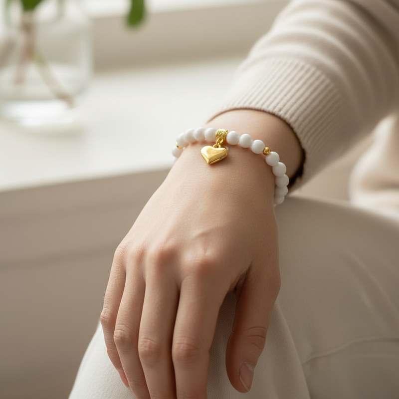 White Czech and Gold Heart Beaded Bracelet On A Womans Wrist.