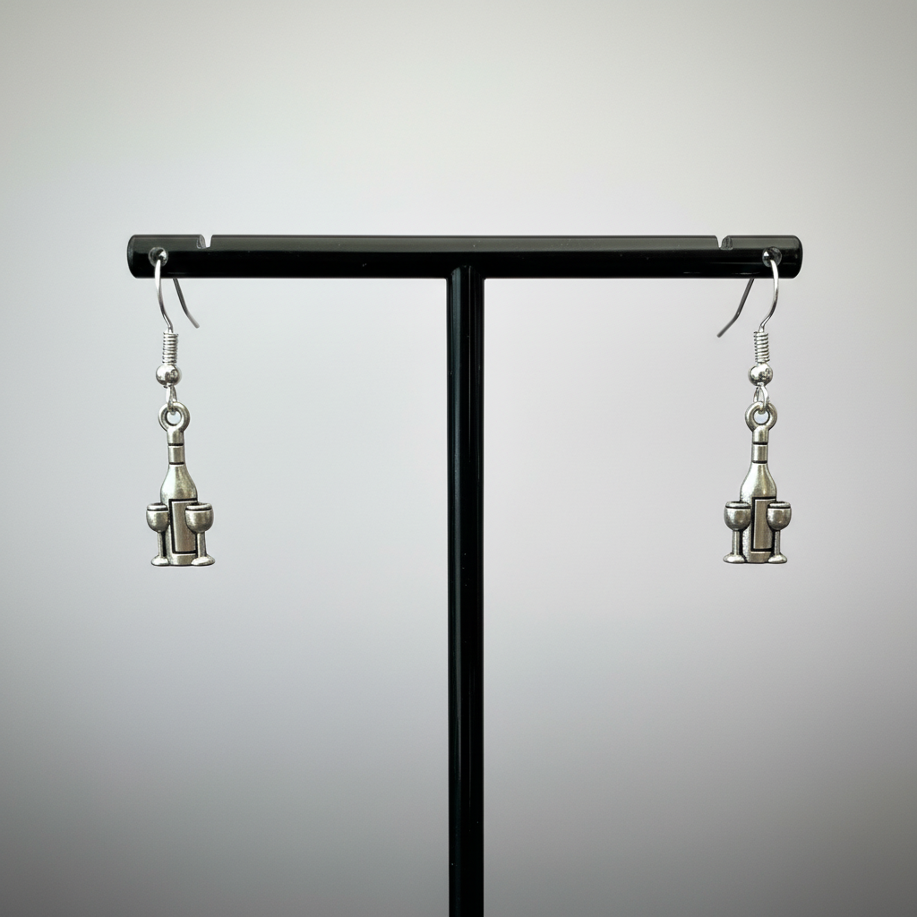 Wine bottle and glass earrings on black stand.